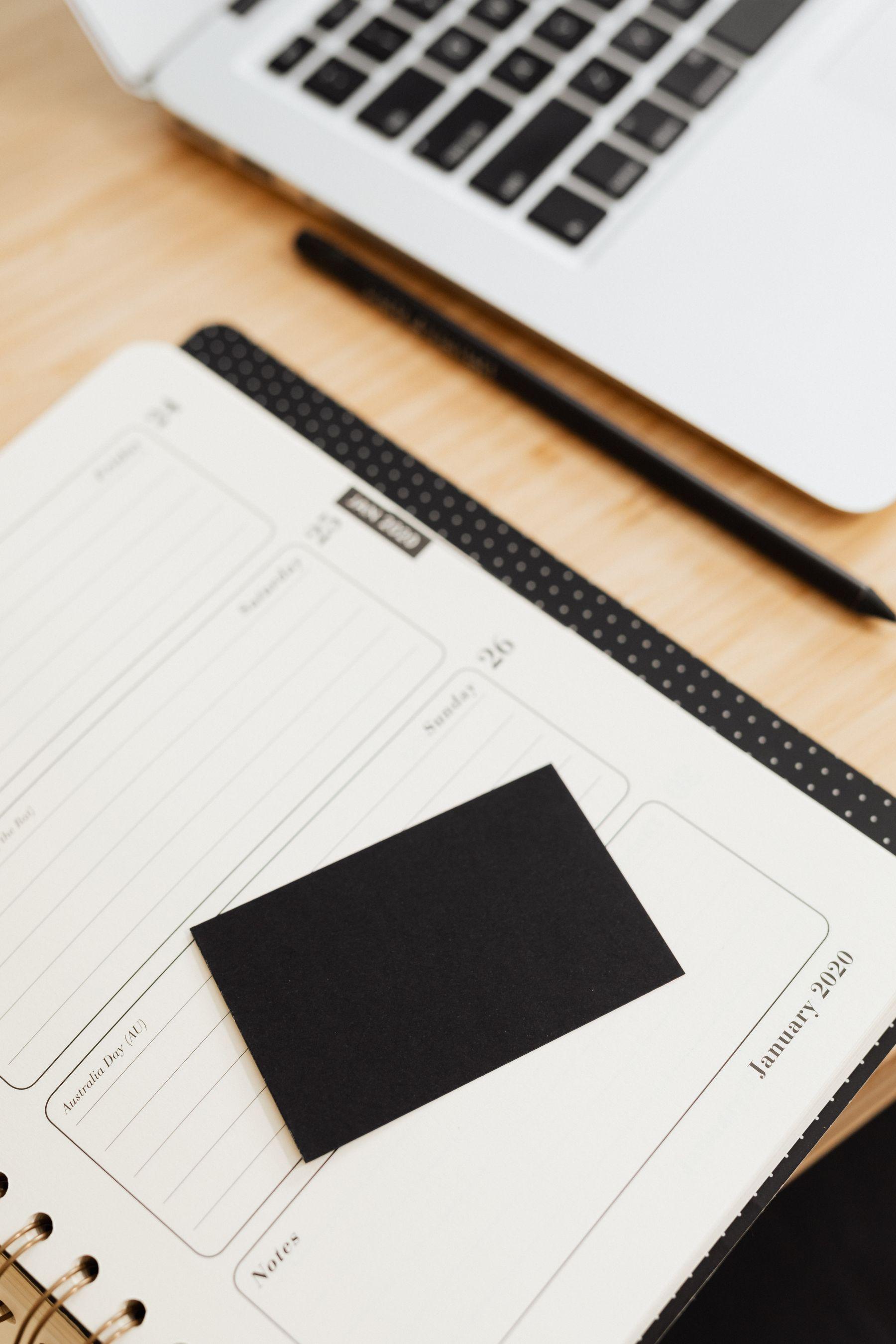 Planner, laptop, and desk notes used to organise manual operational work.