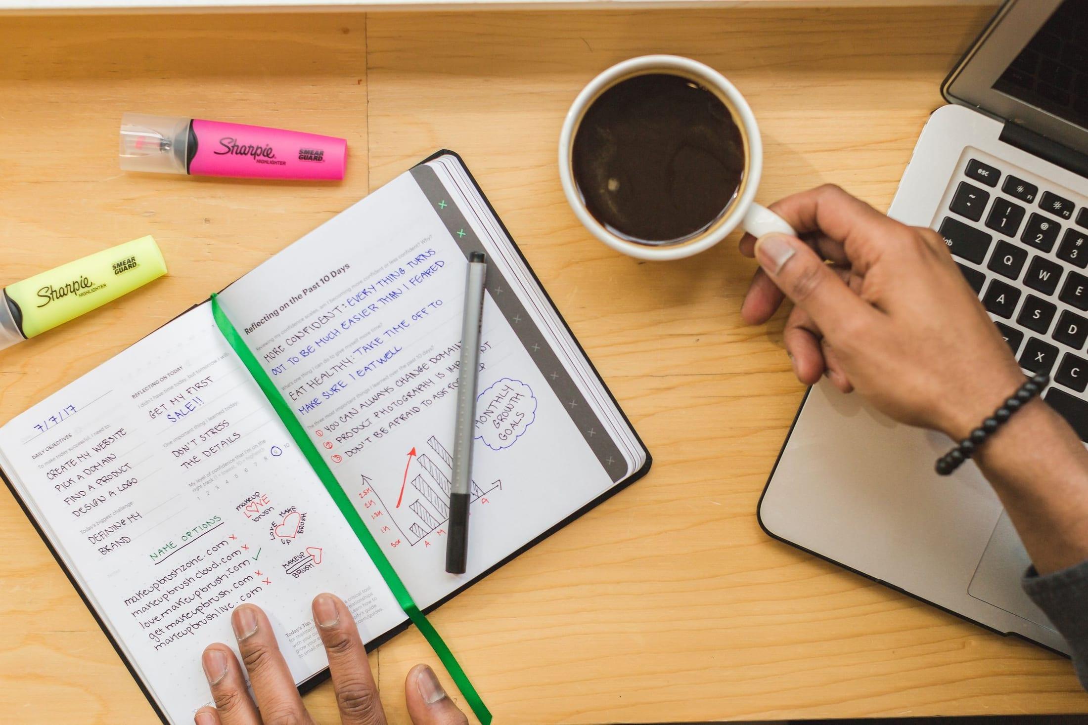 Focused desk setup with laptop and notes for reviewing a business workflow.