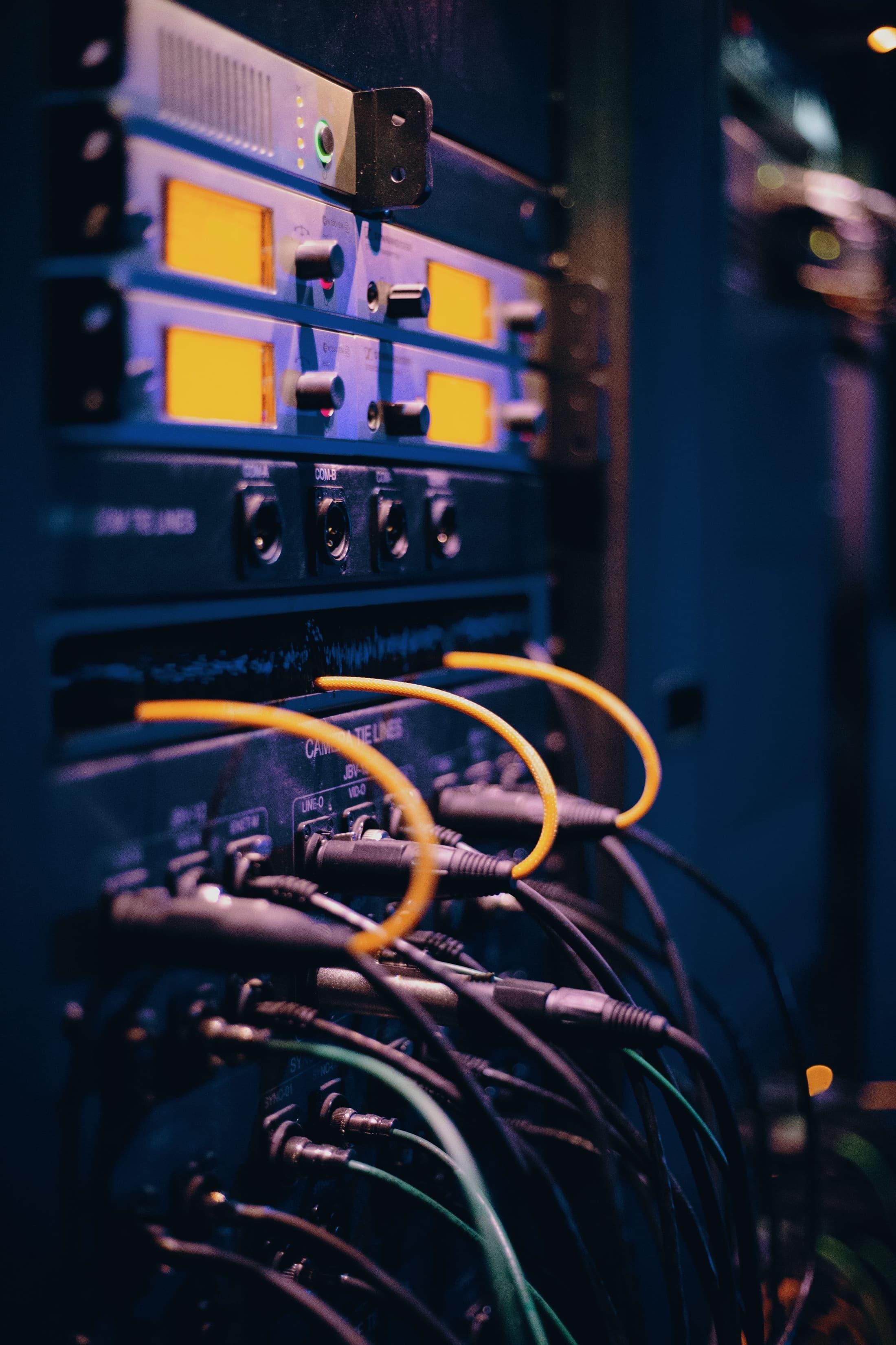 Network rack and cables representing connected business systems.
